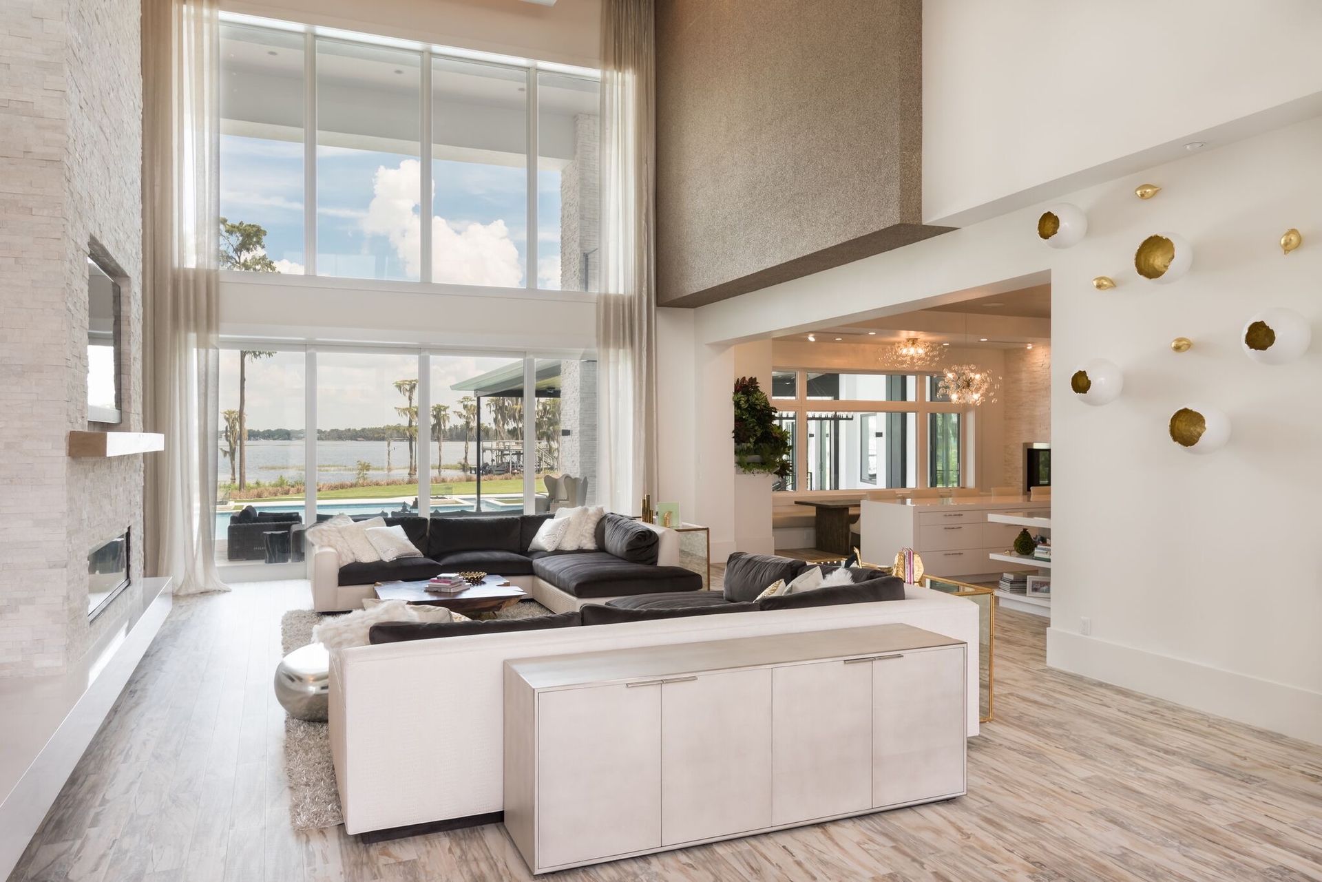 Great room with double-height windows and lake view